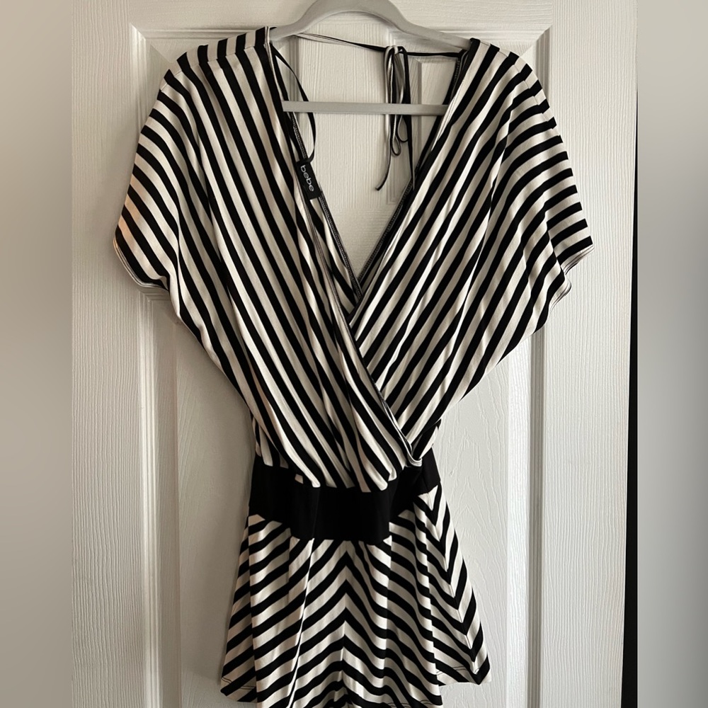 Bebe, extra small stripped romper. Cross over style top that ties in the back.